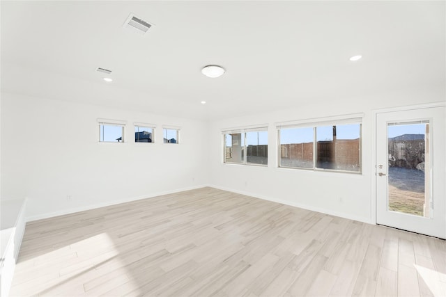 spare room featuring light hardwood / wood-style floors