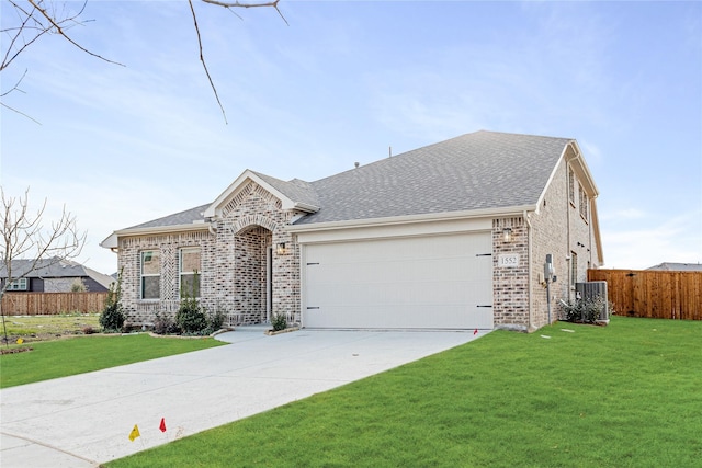 ranch-style house with cooling unit, a garage, and a front lawn