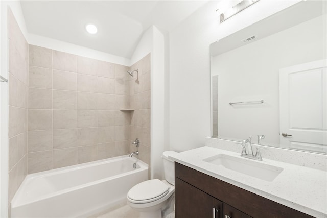 full bathroom featuring tiled shower / bath, vanity, and toilet