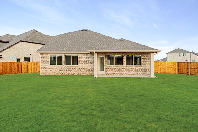 rear view of property with a lawn