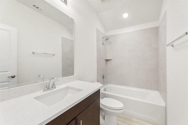 full bathroom with vanity, toilet, and tiled shower / bath