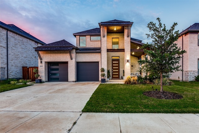 view of front of home featuring a garage and a lawn