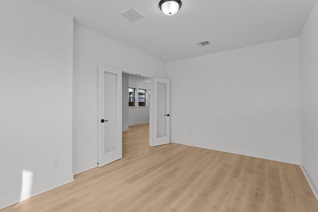 empty room with light hardwood / wood-style flooring