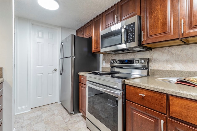 kitchen with stainless steel appliances, tasteful backsplash, and a textured ceiling