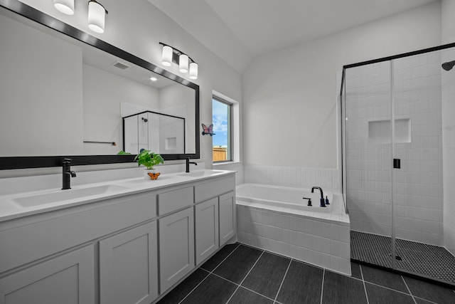 bathroom with tile patterned flooring, vanity, and plus walk in shower