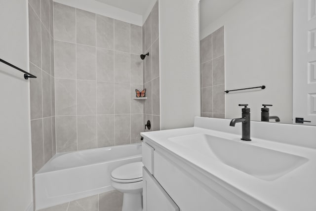 full bathroom featuring tiled shower / bath, vanity, toilet, and tile patterned floors