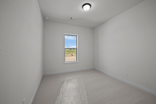 empty room featuring light colored carpet