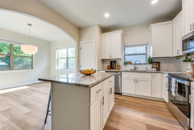 kitchen featuring light hardwood / wood-style flooring, stainless steel appliances, sink, and white cabinetry