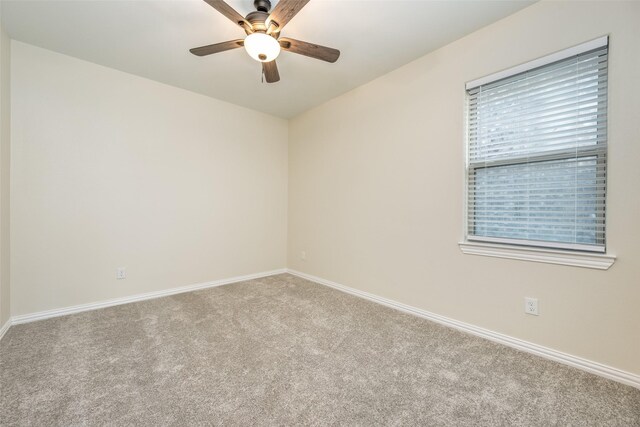 unfurnished room with plenty of natural light, ceiling fan, and light carpet