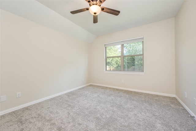 carpeted empty room with vaulted ceiling and ceiling fan