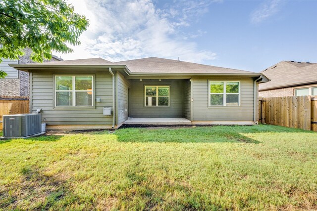 rear view of property with central AC, a yard, and a patio area