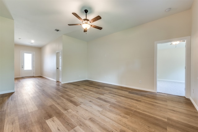 empty room featuring ceiling fan and light wood-type flooring