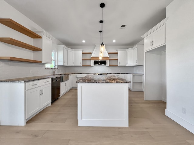 kitchen featuring white cabinetry, decorative light fixtures, a center island, dishwasher, and decorative backsplash