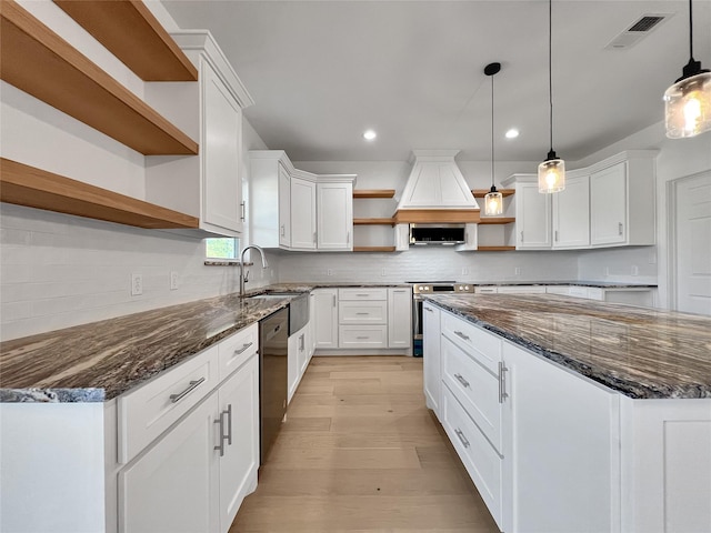 kitchen featuring electric stove, white cabinets, hanging light fixtures, and black dishwasher