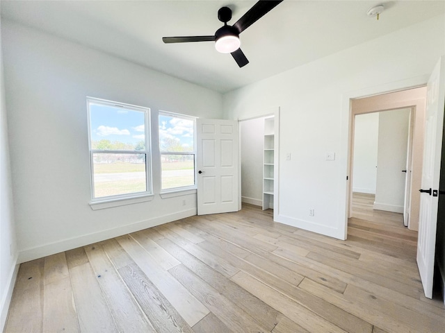 unfurnished bedroom with ceiling fan and light wood-type flooring