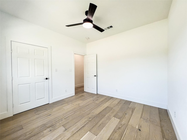 unfurnished bedroom featuring ceiling fan and light wood-type flooring