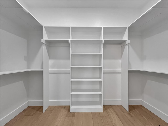 spacious closet featuring light hardwood / wood-style flooring