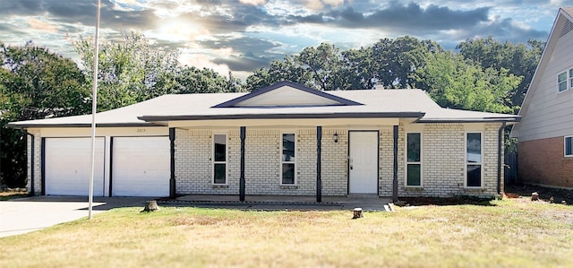 ranch-style house featuring a front yard, a porch, and a garage