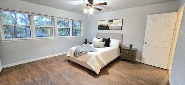 bedroom with ceiling fan and dark hardwood / wood-style floors