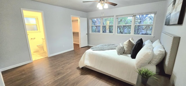 bedroom with ensuite bath, ceiling fan, dark hardwood / wood-style flooring, a spacious closet, and a closet