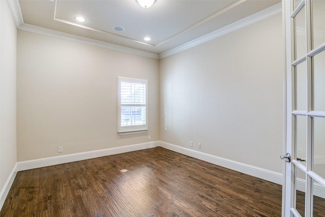 spare room with crown molding and dark hardwood / wood-style flooring