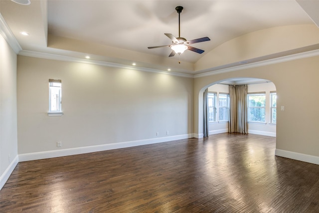 unfurnished room featuring crown molding, ceiling fan, dark hardwood / wood-style floors, and vaulted ceiling