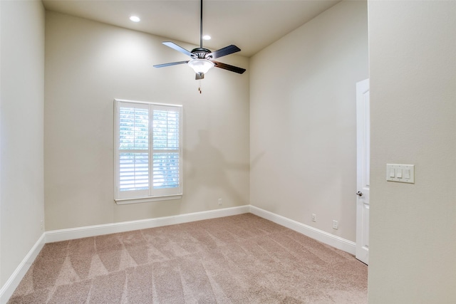 unfurnished room with light colored carpet and ceiling fan