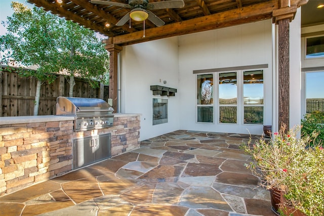 view of patio / terrace featuring area for grilling, a grill, and ceiling fan