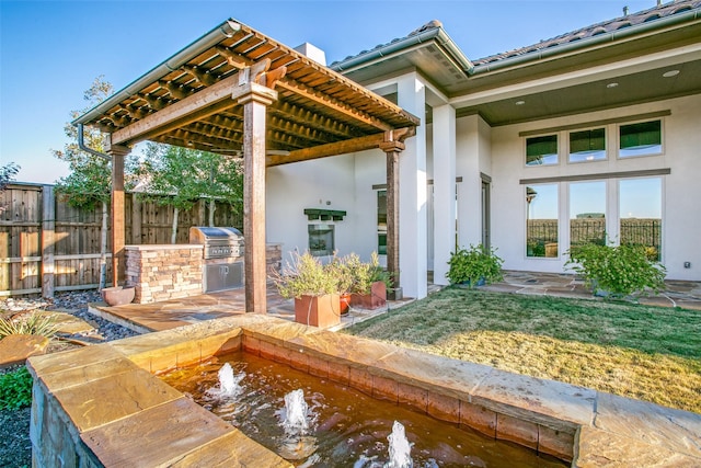 view of patio / terrace featuring a grill and exterior kitchen