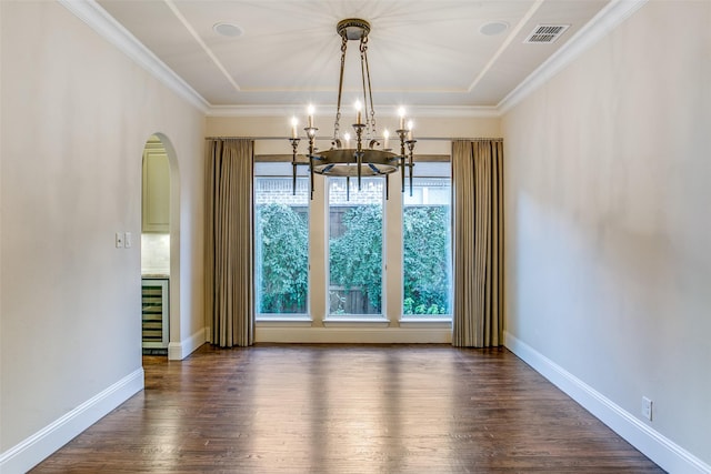 unfurnished dining area with wine cooler, dark hardwood / wood-style flooring, a chandelier, and crown molding