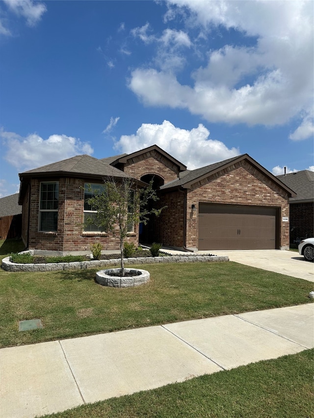 view of front of house with a garage and a front lawn