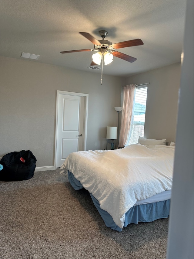 carpeted bedroom with a textured ceiling and ceiling fan