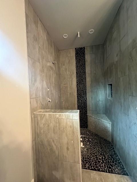 bathroom with a tile shower