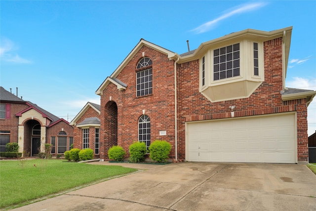 view of front of home featuring a garage and a front yard