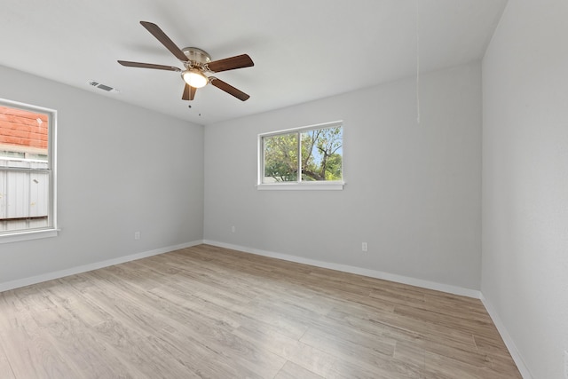 empty room featuring ceiling fan and light hardwood / wood-style floors