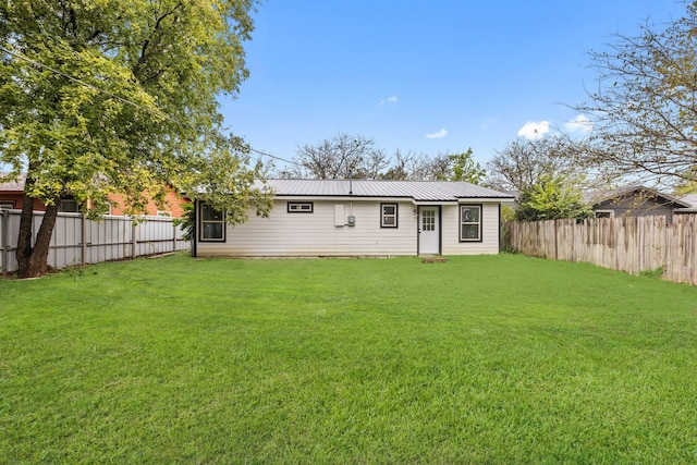 rear view of property with a lawn