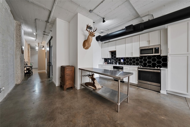 kitchen featuring white cabinetry, appliances with stainless steel finishes, sink, and decorative backsplash