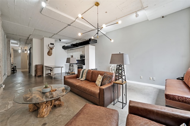 living room featuring an inviting chandelier and track lighting