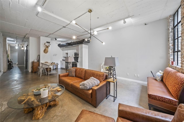 living room featuring concrete flooring and rail lighting