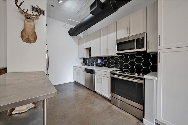 kitchen featuring stainless steel appliances, tasteful backsplash, sink, and white cabinets