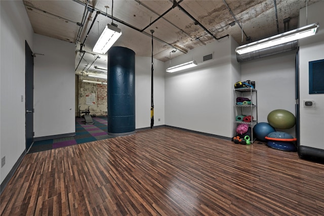 exercise area with dark hardwood / wood-style flooring