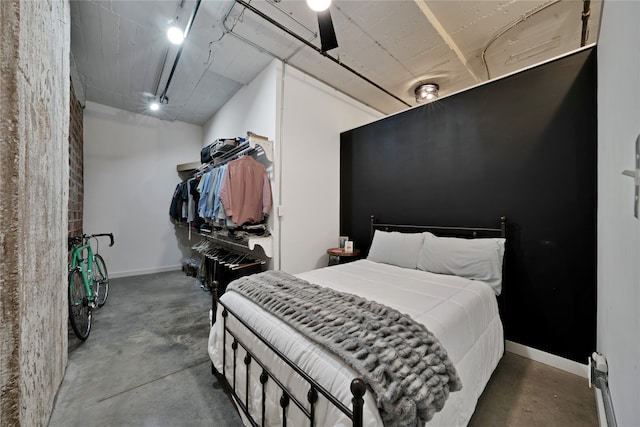 bedroom featuring concrete flooring