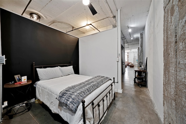 bedroom featuring concrete floors