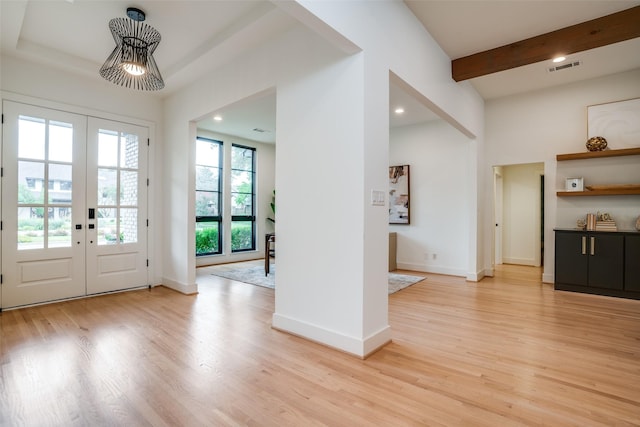 foyer with light hardwood / wood-style floors and french doors