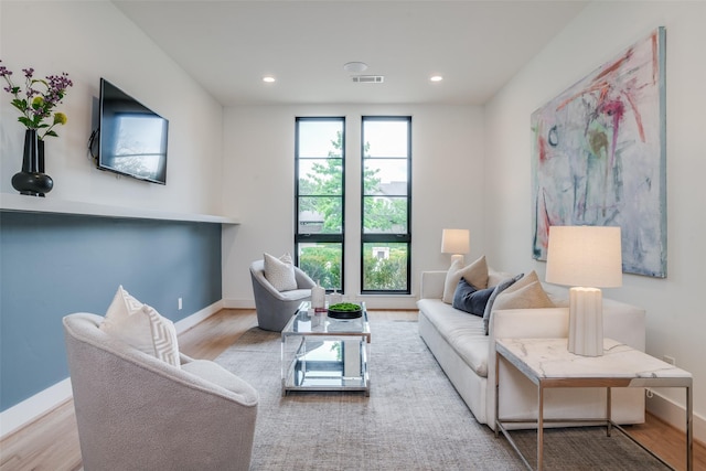 living room with plenty of natural light and light hardwood / wood-style floors