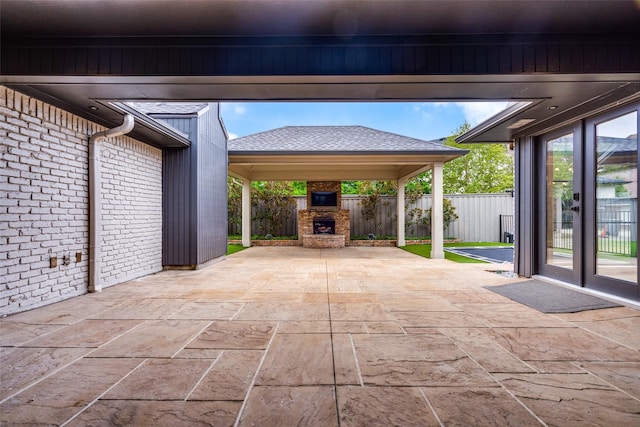 view of patio / terrace featuring an outdoor stone fireplace and a gazebo