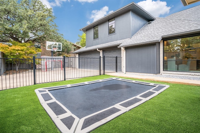 view of sport court featuring a yard