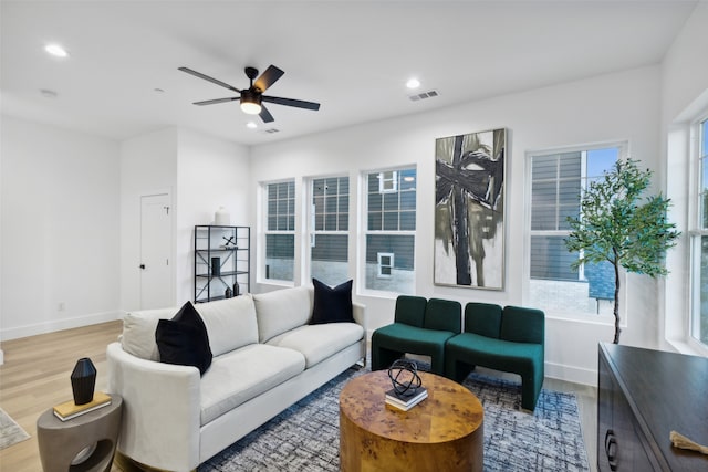 living room featuring ceiling fan and hardwood / wood-style floors