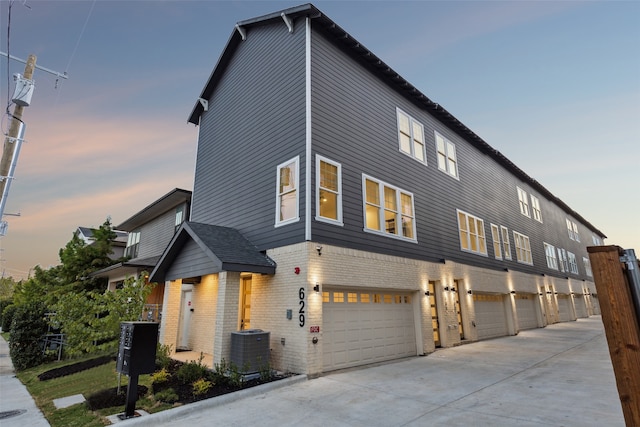 view of front of house featuring a garage and central AC unit