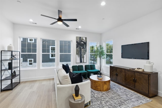 living room featuring ceiling fan and light hardwood / wood-style floors